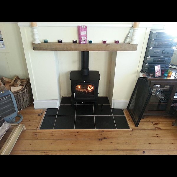 slow burning stove installed in hearth fireplace